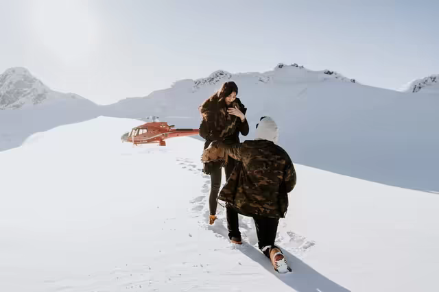 Marriage proposal on a high snowfield in the French Alps, a helicopter landed behind