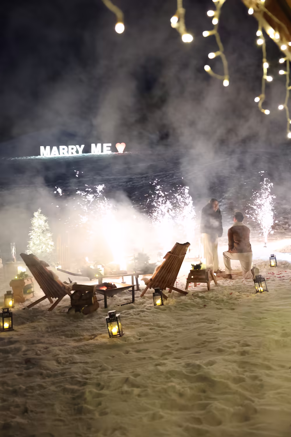 Sparkling fountains lighting up the setting and the Marry Me letters, at night